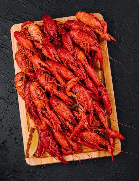 Fragrant boiled crayfish on a wooden board