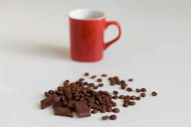 Fragrant coffee in a combination to gentle chocolate and red cup.