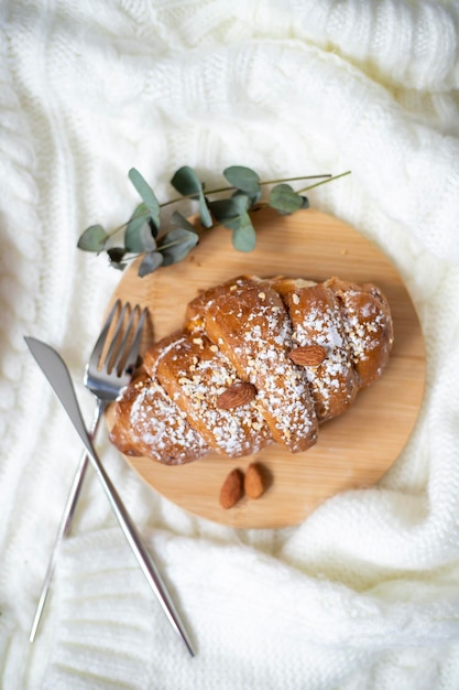 Fragrant fresh croissant on a wooden plate March April May