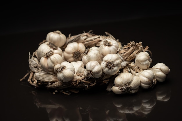 Fragrant Garlic wreath lies on dark background Agriculture and farming