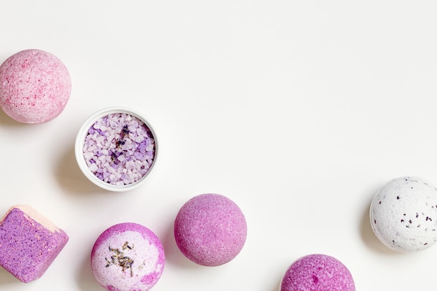Photo fragrant and healthy spa products with essential oil bath bombs and sea salt on white