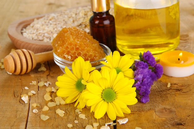 Fragrant honey spa with oils and honey on wooden table close-up