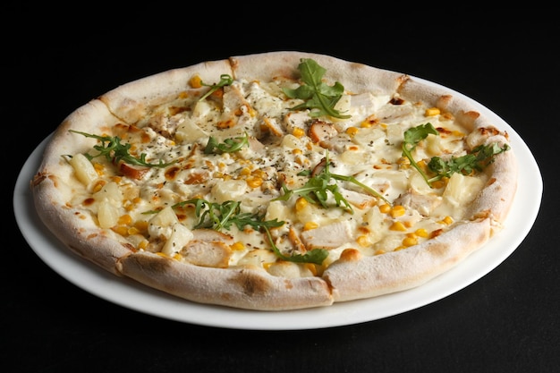 Fragrant and hot pizza on a dark background