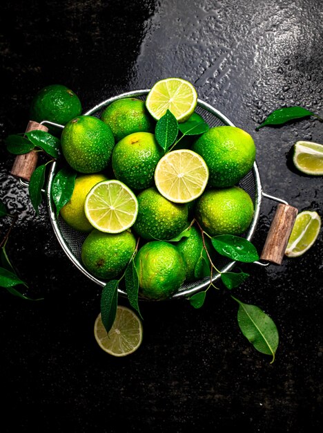 Fragrant lime with leaves in a colander