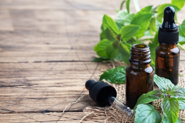 Fragrant mint essential oil in dark glass bubbles