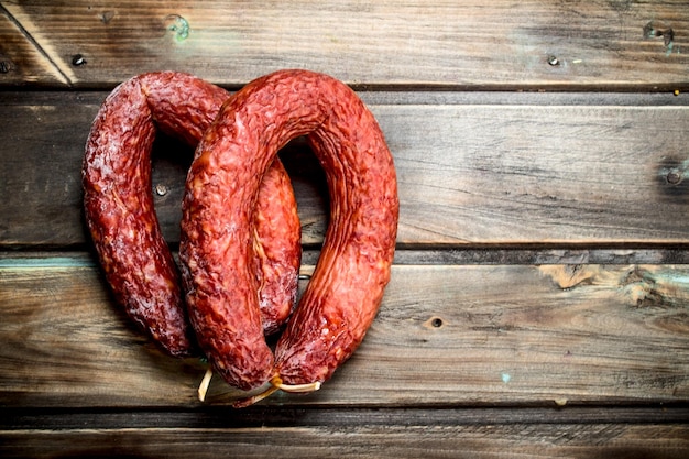 Fragrant salami on wooden background