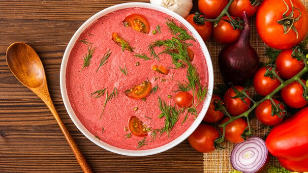 Fragrant tomato soup of cherry tomatoes with the addition of herbs. on a wooden table.  a delicious dish made from fresh products.