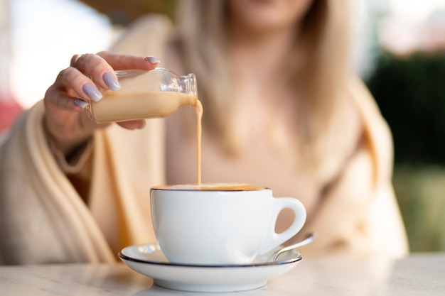 A fragrant and warm mug of cappuccino with a drawing heart pour cream