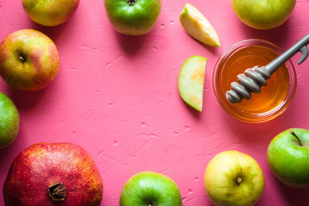 frame of apples pomegranate and honey for the jewish new year horizontal