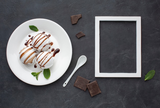 Photo frame beside plate with flavoured ice cream