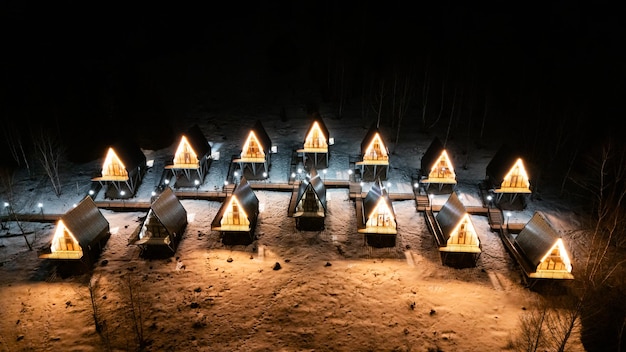 A Frame cabins at night in the winter park