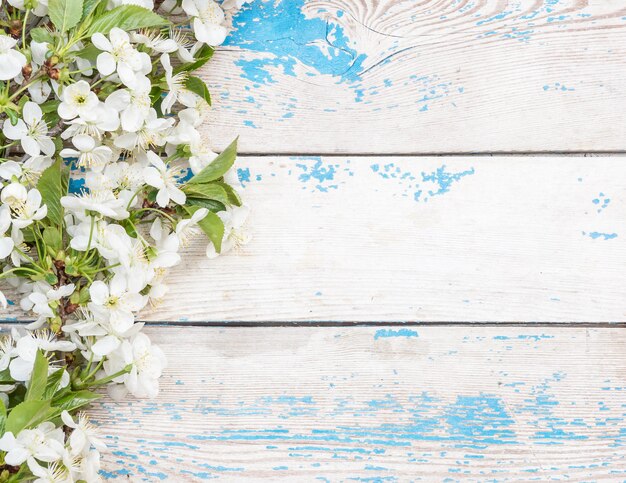 Frame of cherry blossom on the old wooden background Top view