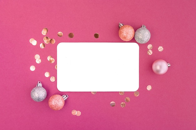 Photo frame of christmas balls and confetti with blank card