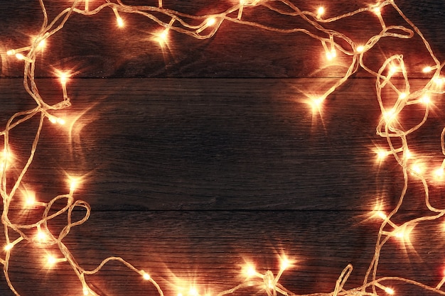 A frame of Christmas garlands on a wooden table. Holidays christmas . copyspace . View from above.