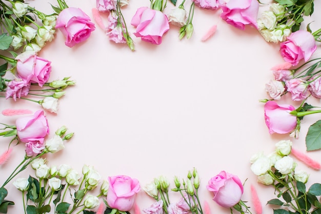 Frame of delicate white and pink roses and eustomas