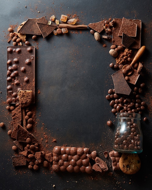 Photo frame of different chocolates on a dark background