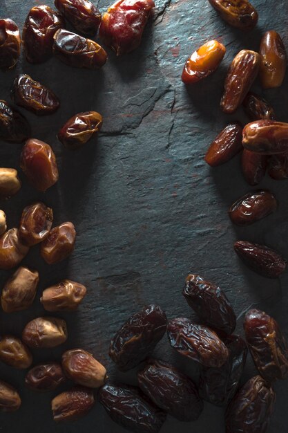 Frame of dried dates on a gray blue table