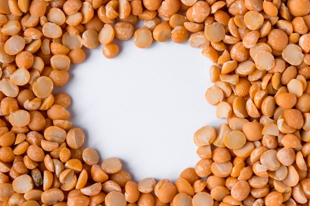 A frame of dry peas beans on a white background. Space for text.