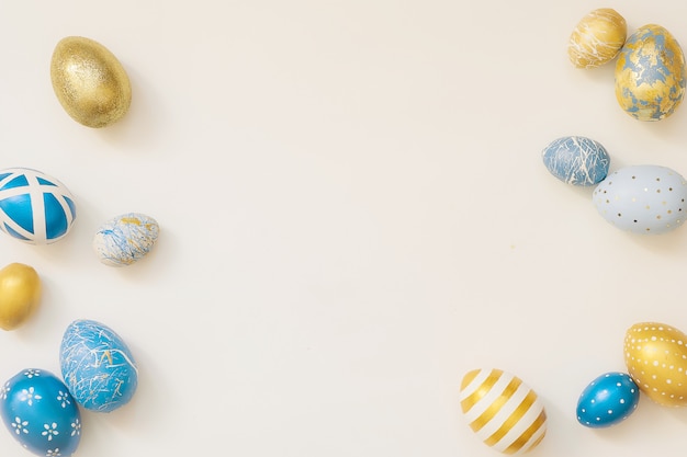 Frame of Easter decorated eggs isolated on white surface.