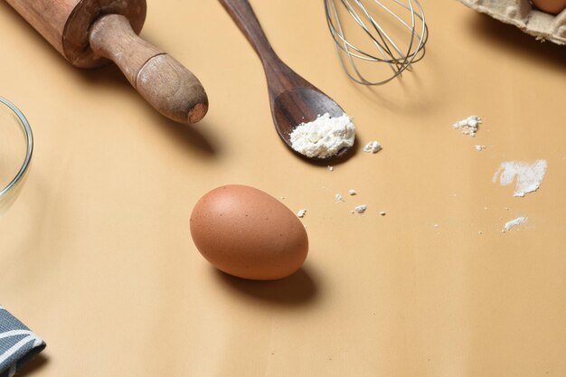 frame of food ingredients for baking on a brown pastel backgroundCooking flat lay with copy space