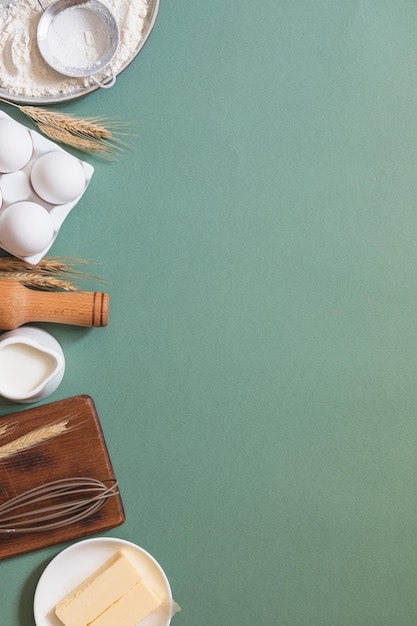 Frame of food ingredients for baking on a green pastel background Cooking flat lay with copy space Top view Baking concept Mockup