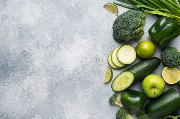 Frame Fresh green vegetables and herbs on a grey concrete