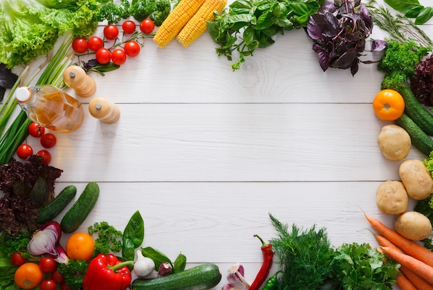 Frame of fresh vegetables on white wood with copy space