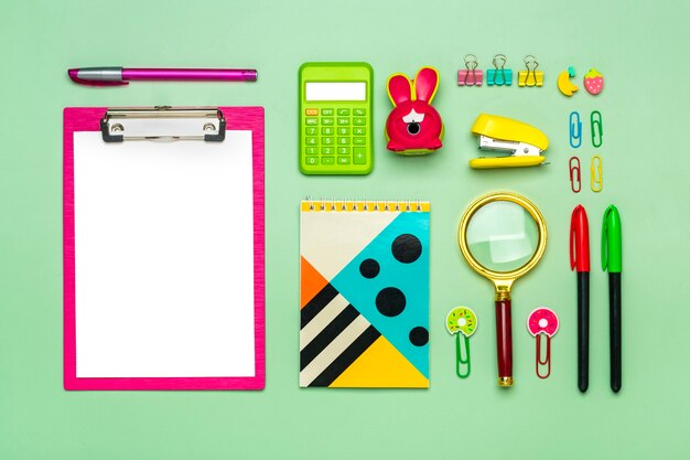Photo frame from of office supplies on green background