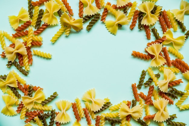 Photo frame from wheat pasta on red background.