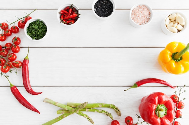 Frame of healthy spicy food on white wooden