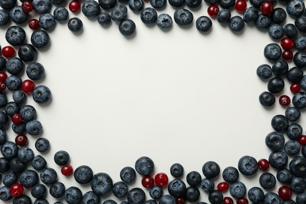 Frame made of fresh berries on white