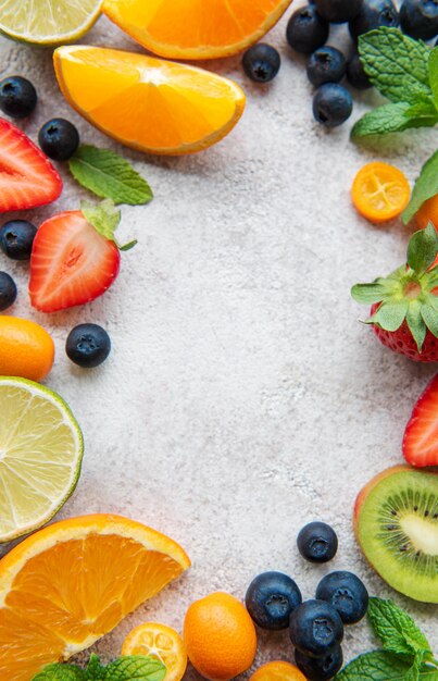 Frame made of ripe fruits on a concrete background