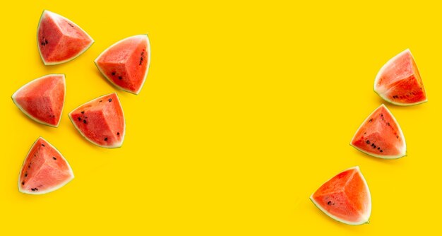 Photo frame made of watermelon on yellow background.