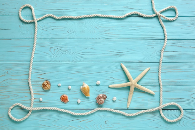 Frame made of white rope on wooden blue background