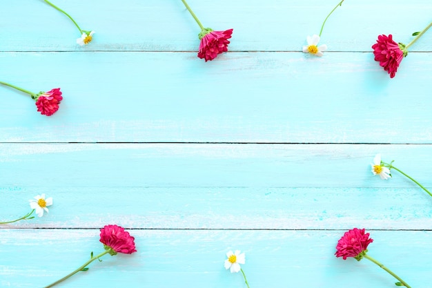 Frame made of white wild flowers and red chrysanthemum flowers 