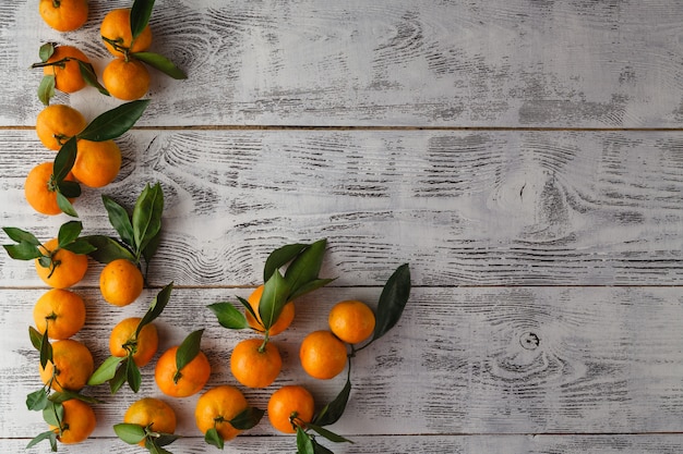 Frame of mandarins on the wooden table horizontal