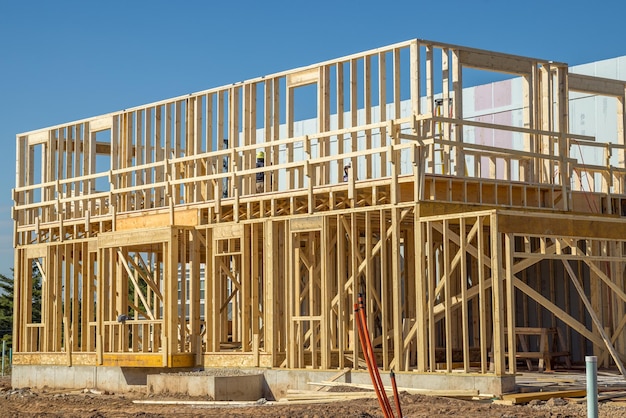 frame of a new house against a blue sky plywood room truss