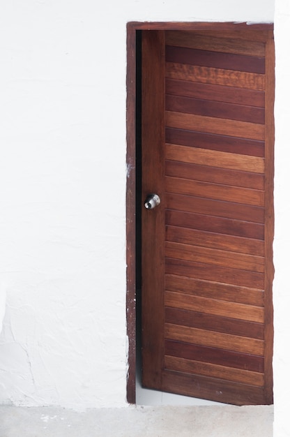 Frame and panel wooden door on white wall background,Frontal image of a open wood door