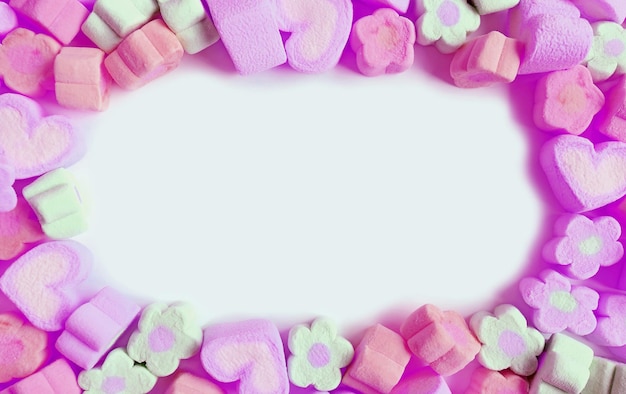 Frame of Pastel Colored Flower and Heart Shaped Marshmallow Candies