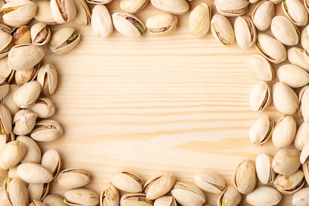 Frame of pistachios on wooden table