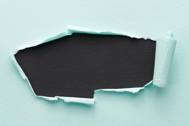 frame of ripped paper with torn edges window for text with copy space black blue colors shreds of notebook pages abstract background
