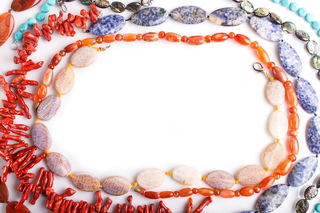 Frame of semiprecious stone beads on white surface