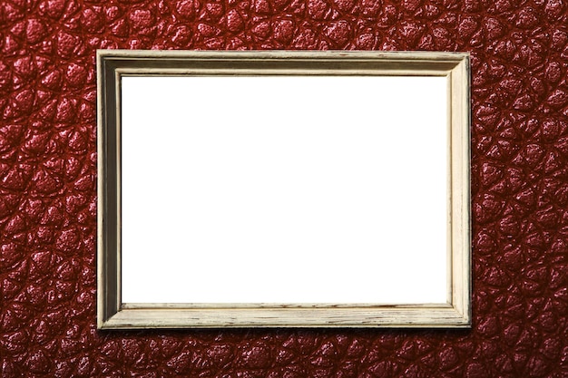 Photo frame on a textural brown wall. isolated on white