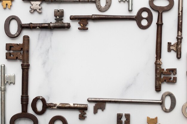 Frame of vintage keys on white background safety and security concept