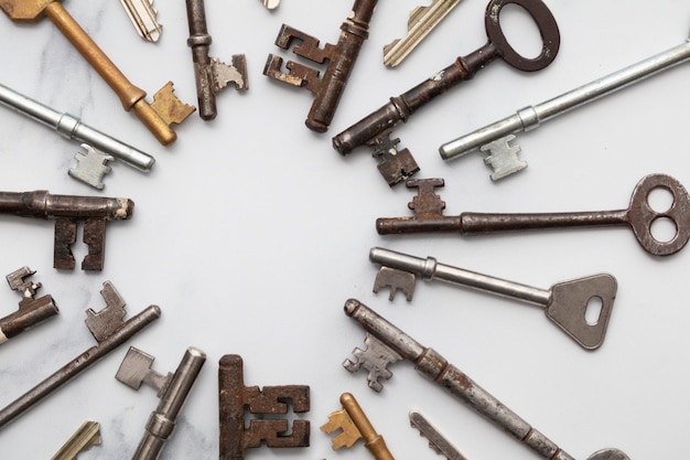 Frame of vintage keys on white background Safety and security concept