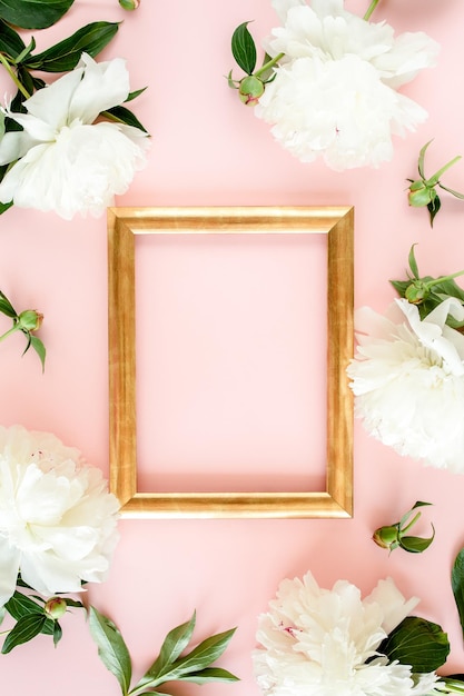 Frame of white peony flowers with space for text on pink background peony texture flat lay top view