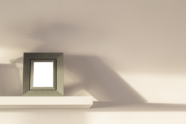 Frame on white wooden shelf on white background