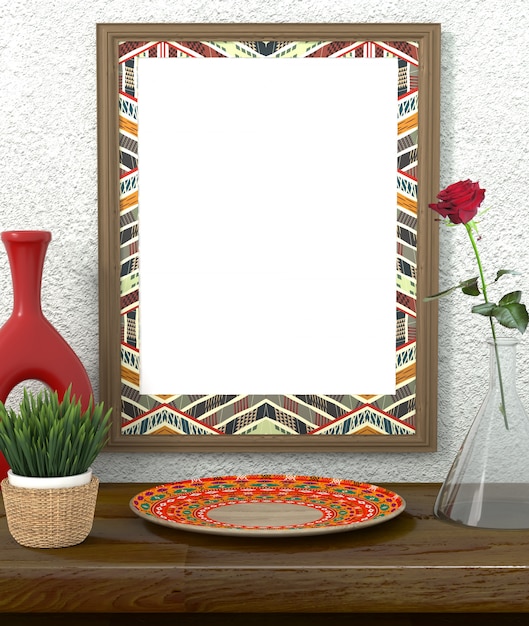 Frame with bright ethnic ornament. Green grass in a pot on a wooden table. Red Rose in a glass vase. 