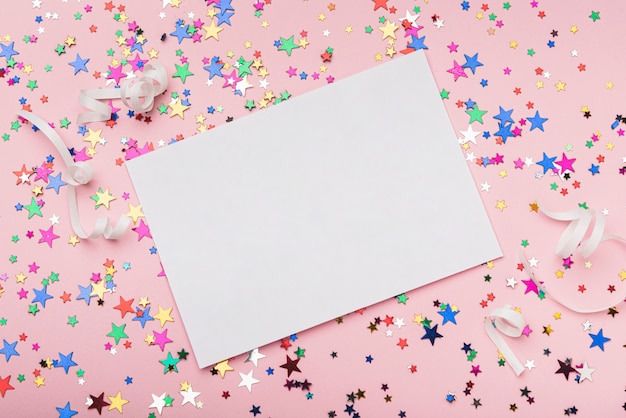 Photo frame with colorful confetti stars on pink background