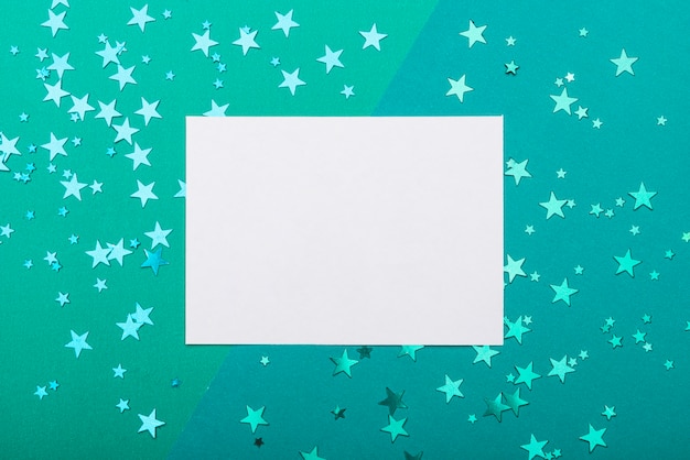 Photo frame with confetti stars on turquoise background